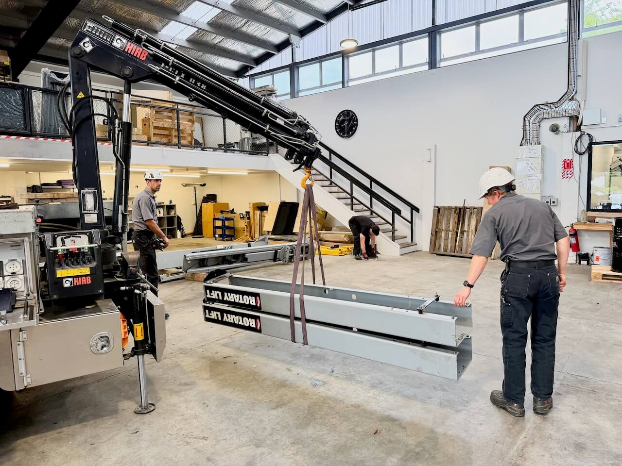 Technicians installing a vehicle hoist